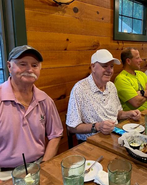 Three smiling golfers...