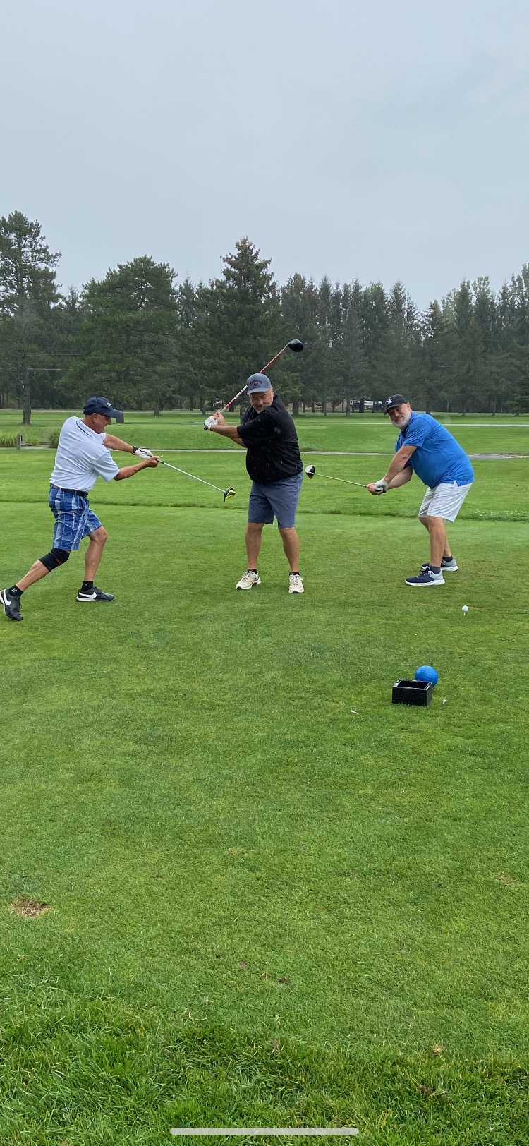 A group of men playing golf

Description automatically generated